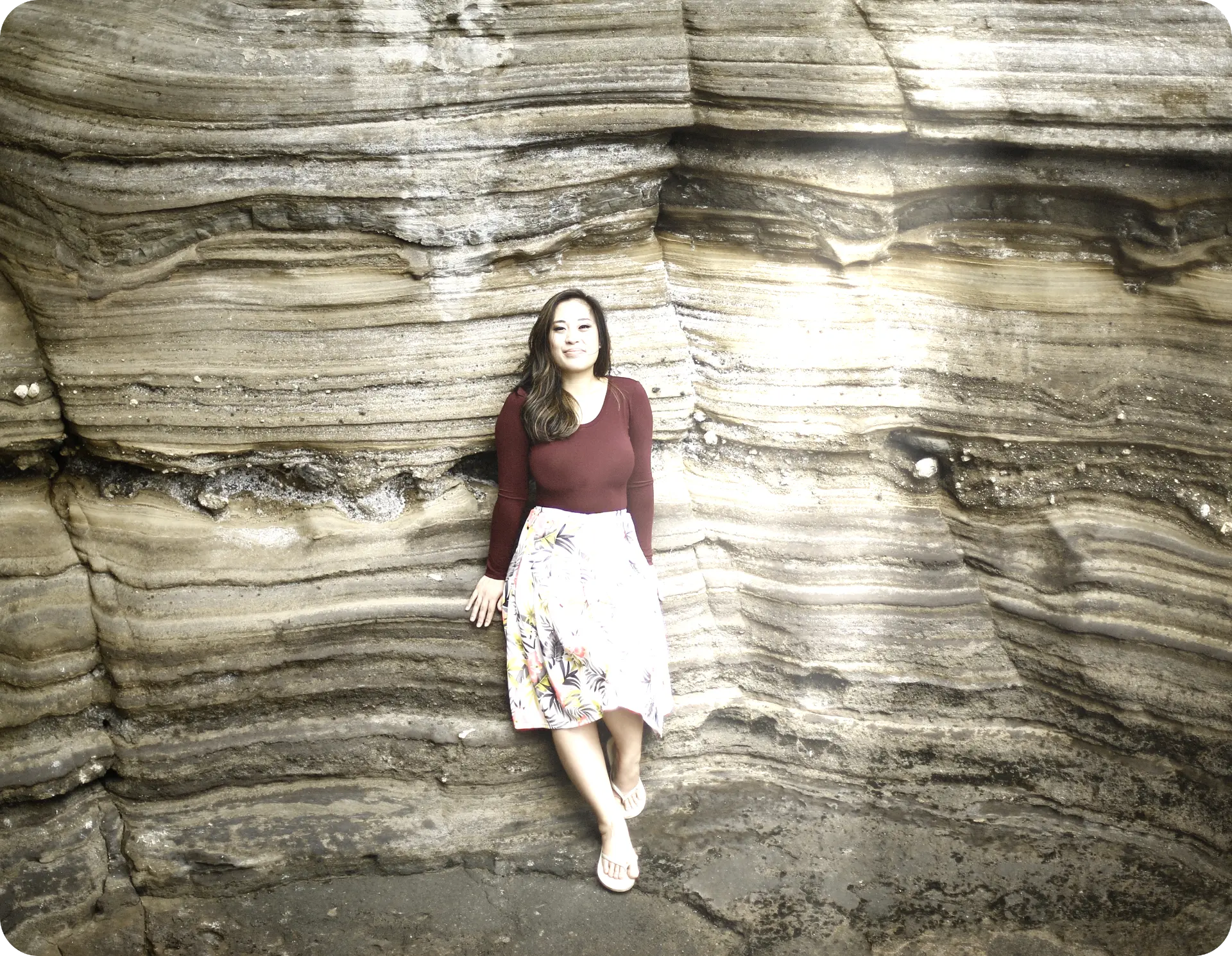 Portrait of Kim Cinco standing against a layered rock wall